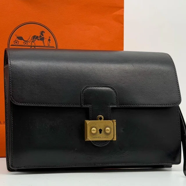 Hermès Pochette Jet Box Calf in Box leather from The Reluxe