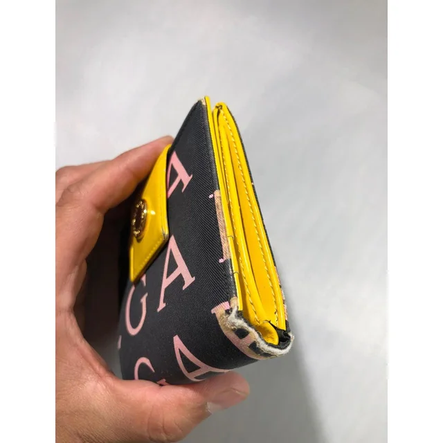 Bvlgari Women's Wallets - Black/Yellow in yellow|black from Depop, photo 8 of 9