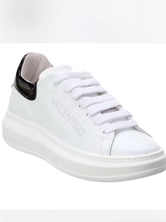Valentino Garavani White Leather Low-Top Sneaker With Black Heel Tab in black|white Leather from Poshmark