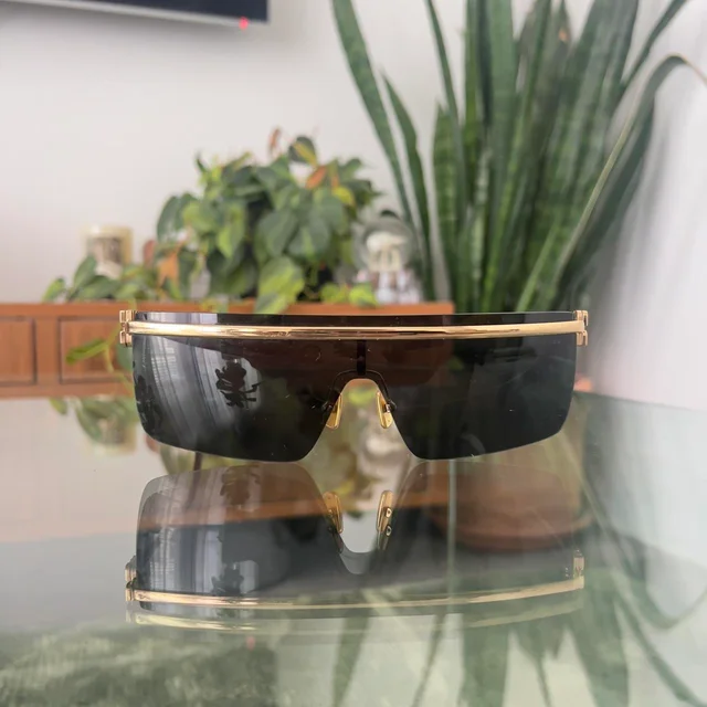 Miu Miu Women's Oversized Sunglasses - Black/Gold in gold|black from Depop, photo 3 of 6
