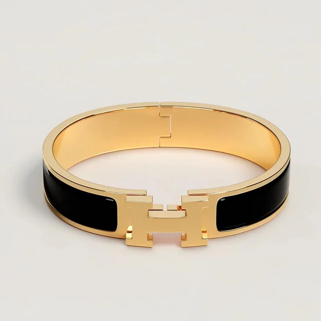 Hermès Women's Bracelet - Gold/Black in black|gold from Depop, photo 1 of 1