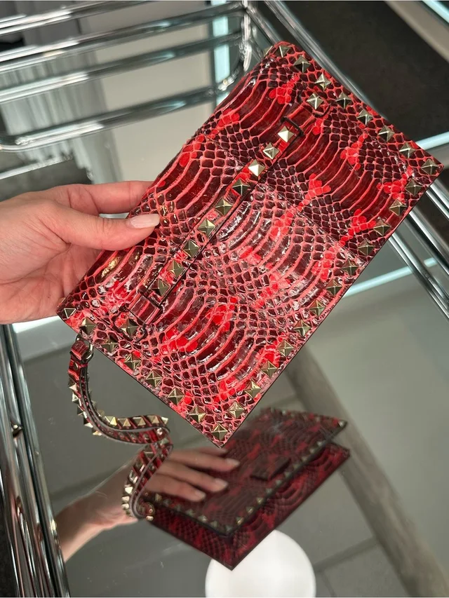 Valentino Garavani Rock-Stud Clutch Wristlet in red from Poshmark, photo 1 of 1