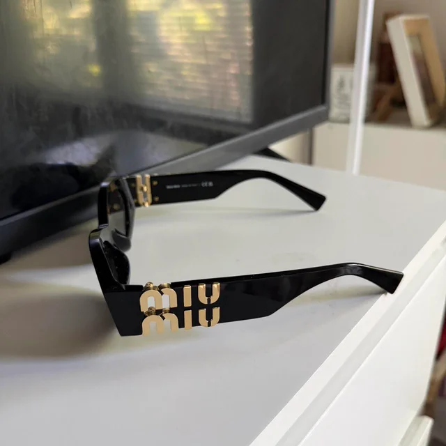 Miu Miu Women's Sunglasses - Black in black from Depop, photo 7 of 8