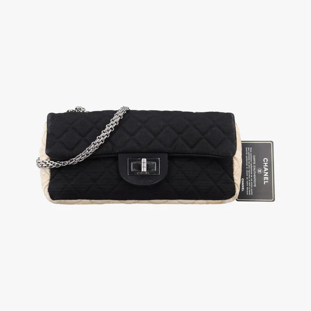 Chanel Quilted 2.55 Black Beige Fabric Handbag in Black from The Reluxe