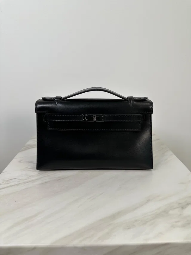 Hermès Kelly Pochette So Black Box Leather in Black Box leather from Luxury Promise