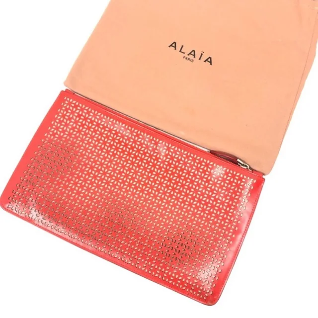 Alaïa Clutch Pochette Laser Cut Out Bag Leather in neutral|red|brown Leather from Poshmark, photo 1 of 1