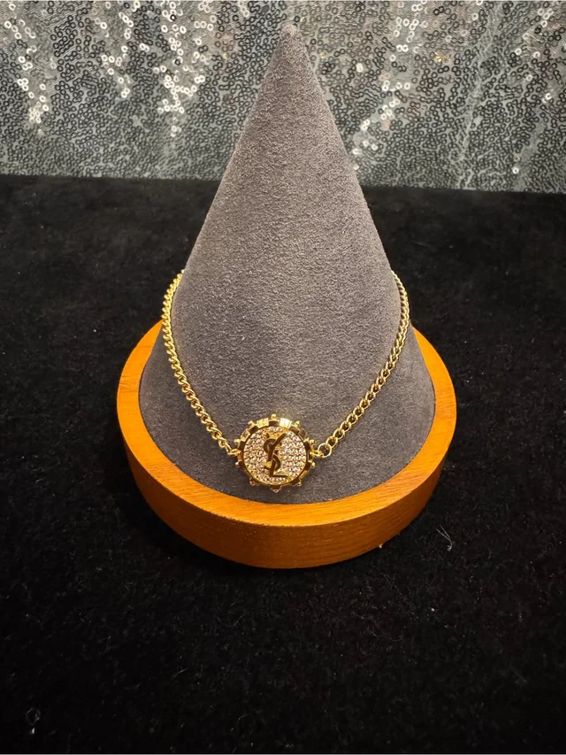 Saint Laurent Gold-Tone Crystal Logo Medallion Bracelet in gold|gray|silver from Poshmark