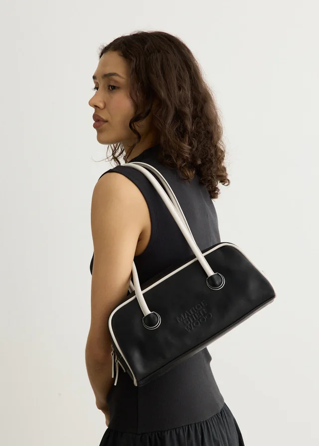 MARGESHERWOOD Soft Baguette Bag With Piping in Black from Incu, photo 1 of 1