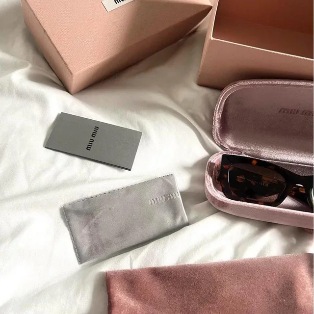 Miu Miu Women's Cat eye Sunglasses - Brown/Black in red|black|brown from Depop, photo 3 of 6