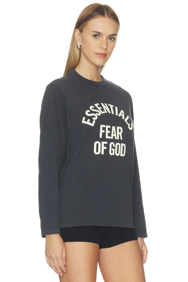 Fear of God ESSENTIALS Campus Classic Long Sleeve Tee in Faded Black, photo 2 of 5 from REVOLVE (Canada)