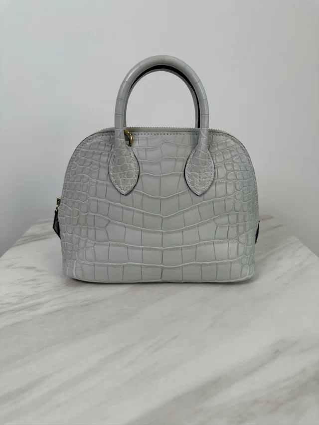 Hermès Mini Bolide Gris Neve Matte Alligator Gold Hardware in Grey Crocodile from Luxury Promise