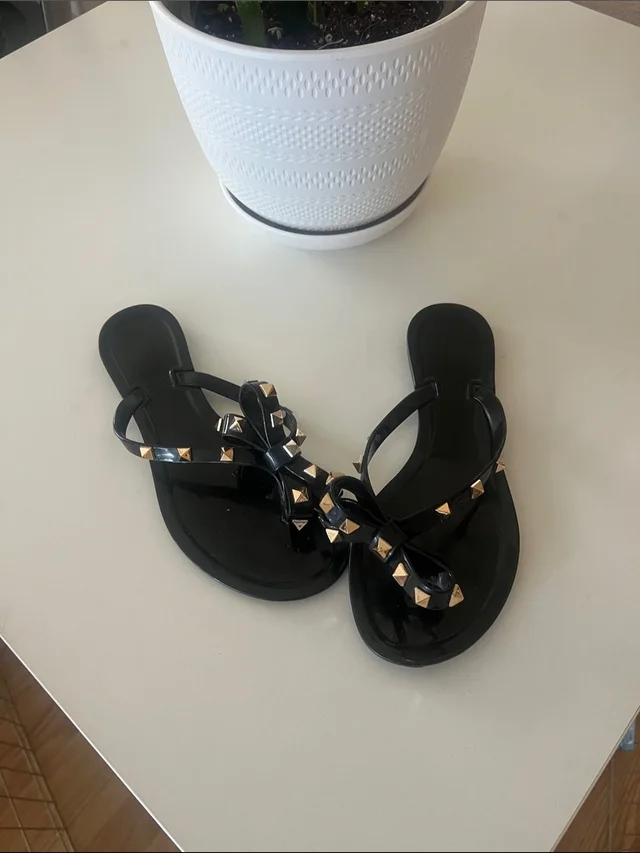 Valentino Garavani Black Jelly Sandals With Gold Pyramid Studs - Bow Accent in black|gold from Poshmark, photo 1 of 1