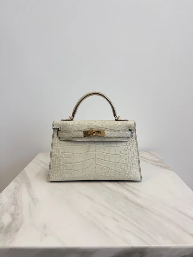 Hermès Mini Kelly Beton Matte Croc Permabrass Hardware in Crocodile from Luxury Promise
