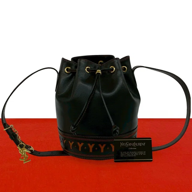 Saint Laurent Logo Cutout Leather Drawstring Shoulder Bag Black Orange in Black Leather from The Reluxe