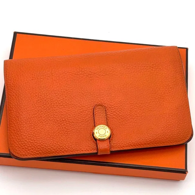 Hermès Wallet Dogon GM Taurillon Clemence Orange Gold in Orange Clemence leather from The Reluxe
