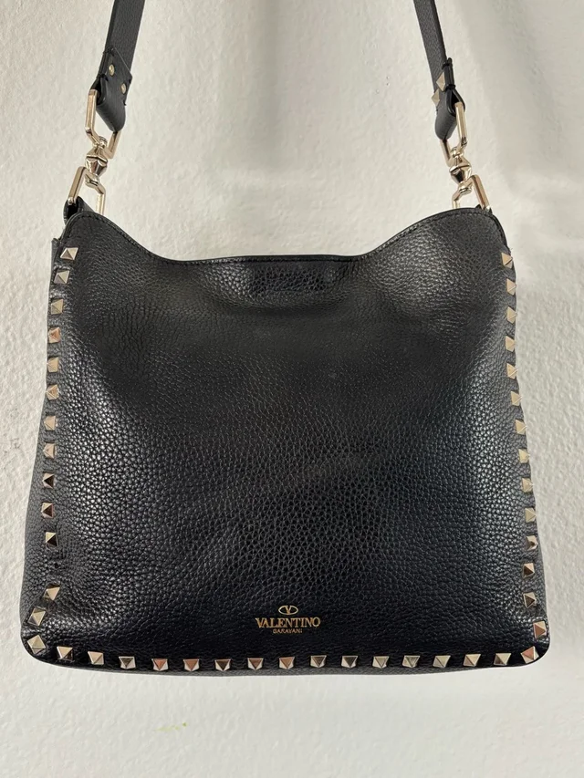 Valentino Garavani Rockstud Black Pebbled Leather Messenger Crossbody Bag in black Leather from Poshmark, photo 1 of 1