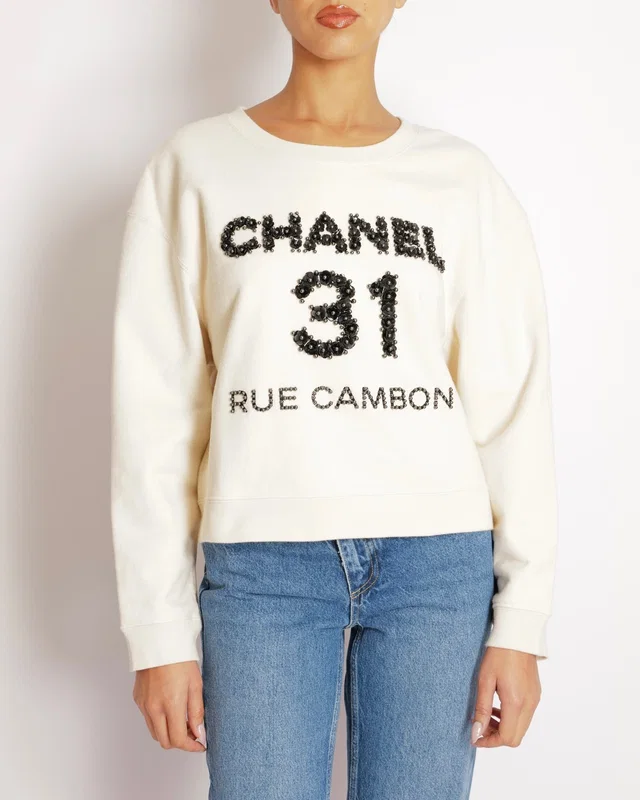 Chanel Pre-Fall 2020 Beige 31 Rue Cambon Sweater with Black Floral Appliqué Logo Size L (UK 12) in Black from Sellier
