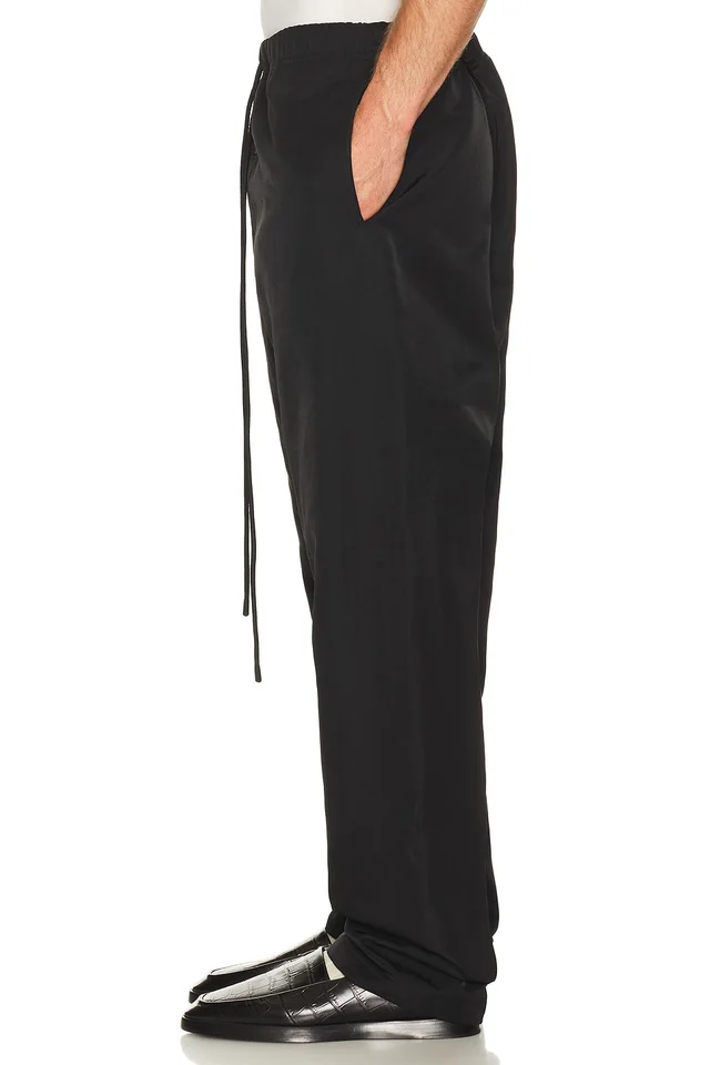 Fear of God ESSENTIALS Active Trace Relaxed Drawstring Pant in Vintage Black, photo 3 of 7 from REVOLVE (Canada)