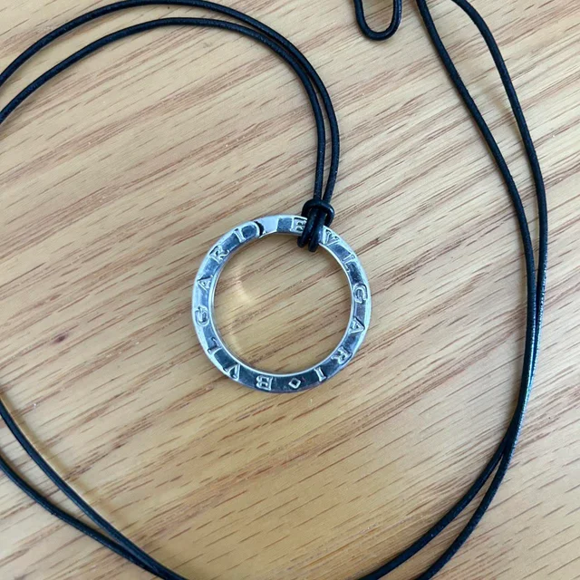 Bvlgari Women's Necklace - Silver/Black in silver|black|gray Leather from Depop, photo 1 of 1