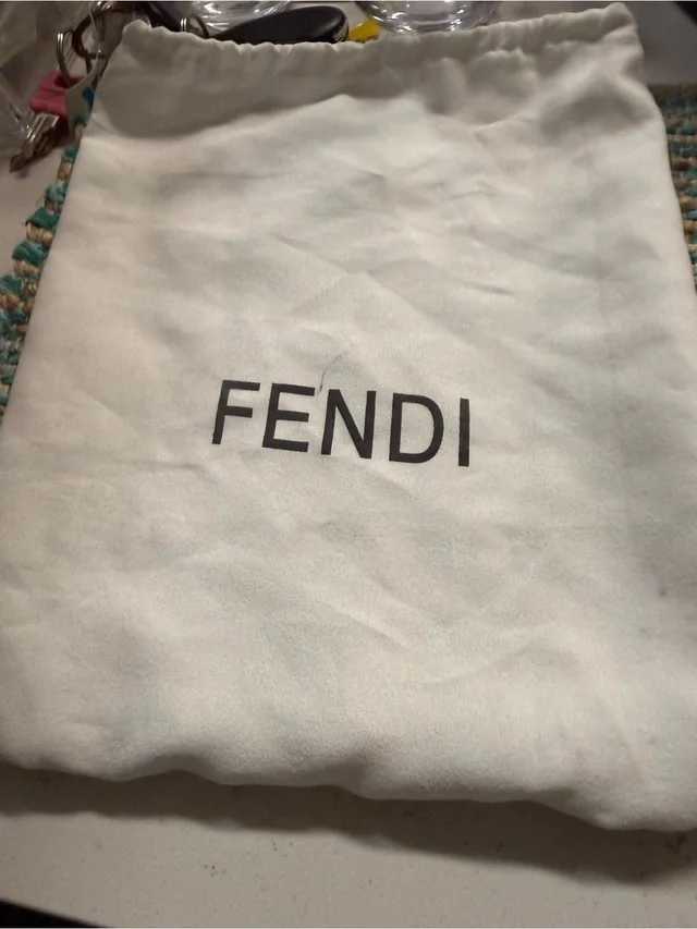 Fendi Cream Drawstring Dust Bag With Black Logo in black|white from Poshmark, photo 1 of 1