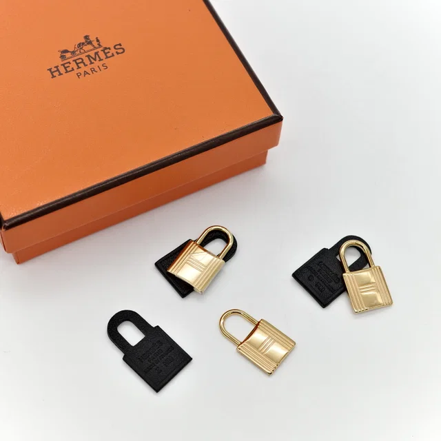 Hermès gold-tone chain and black leather pendant set from Popchill