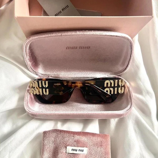 Miu Miu Women's Cat eye Sunglasses - Brown/Black in red|black|brown from Depop, photo 2 of 6