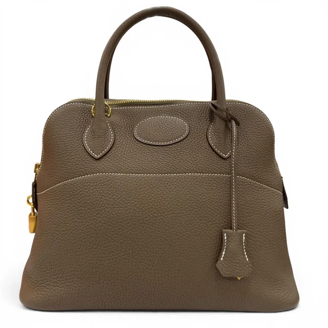 Hermès Bolide 31 Taurillon Clemence Etoupe Gold Handbag in Taupe Clemence leather from The Reluxe