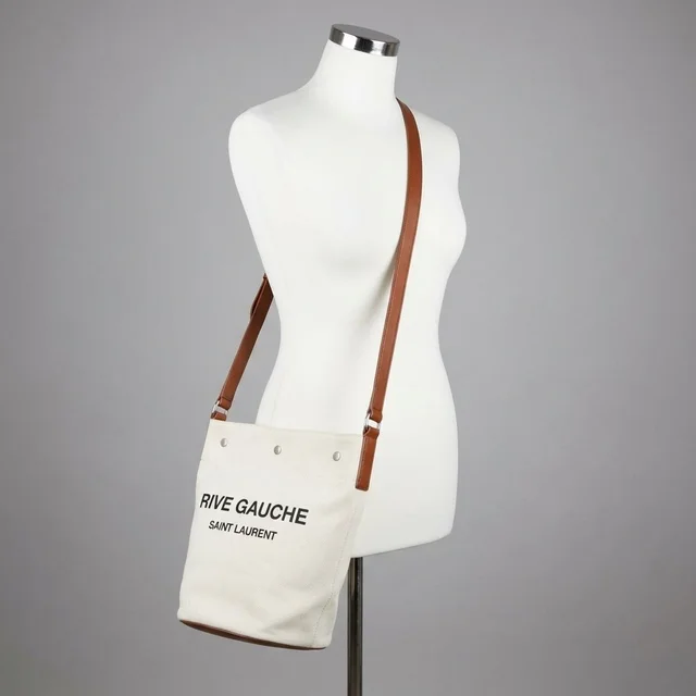 New Saint Laurent Women's Rive Gauche Leather Bucket Bag In Brown in brown|red Leather from Poshmark, photo 1 of 1