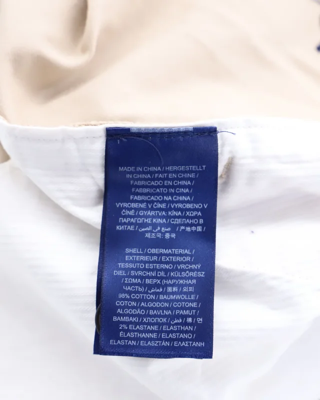 Gant High-Waisted Crest Embroidery Pleated Chinos in Beige Print Cotton in Beige, photo 6 of 6 from ShopSimon