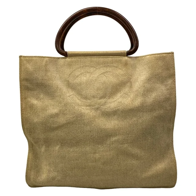 Chanel Tote Bag Ivory CC Logo Gold Wood Look Handle Lambskin in White Lambskin from The Reluxe