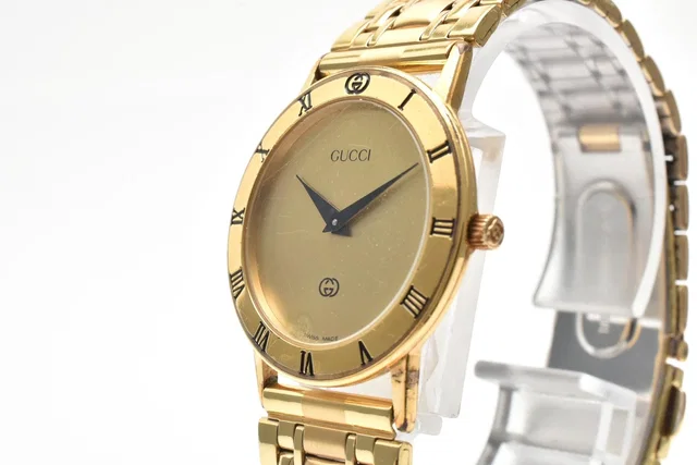 Gucci Quartz Watch Gold Dial 2 Hand Roman Numeral Bezel Plate Stainless Steel in Gold from The Reluxe
