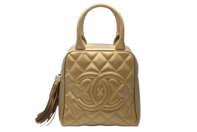 Chanel Handbag Caviar Leather CC Logo Fringe Gold in Gold Caviar leather from The Reluxe