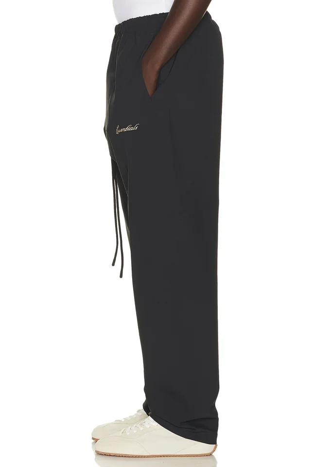 Fear of God ESSENTIALS Signature Track Pant in Vintage Black, photo 2 of 6 from REVOLVE (Canada)