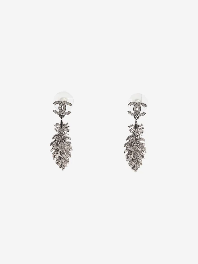 Chanel Silver CC logo feather dangle earrings in Silver from Sign of the Times