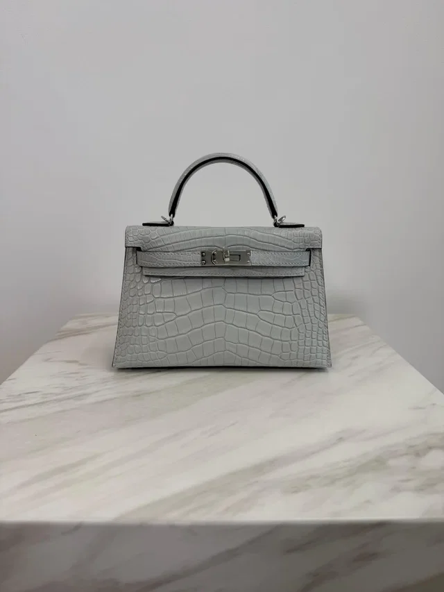 Hermès Mini Kelly Gris Neve Matte Alligator Palladium Hardware in Grey Crocodile from Luxury Promise