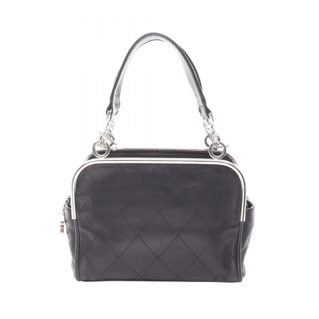Chanel Handbag Quilted Black Lambskin Coco Charm in Black Lambskin from The Reluxe