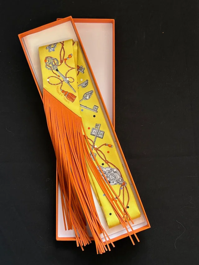 Hermès Twilly Fringe - Yellow / Orange in Orange Silk from Luxury Promise