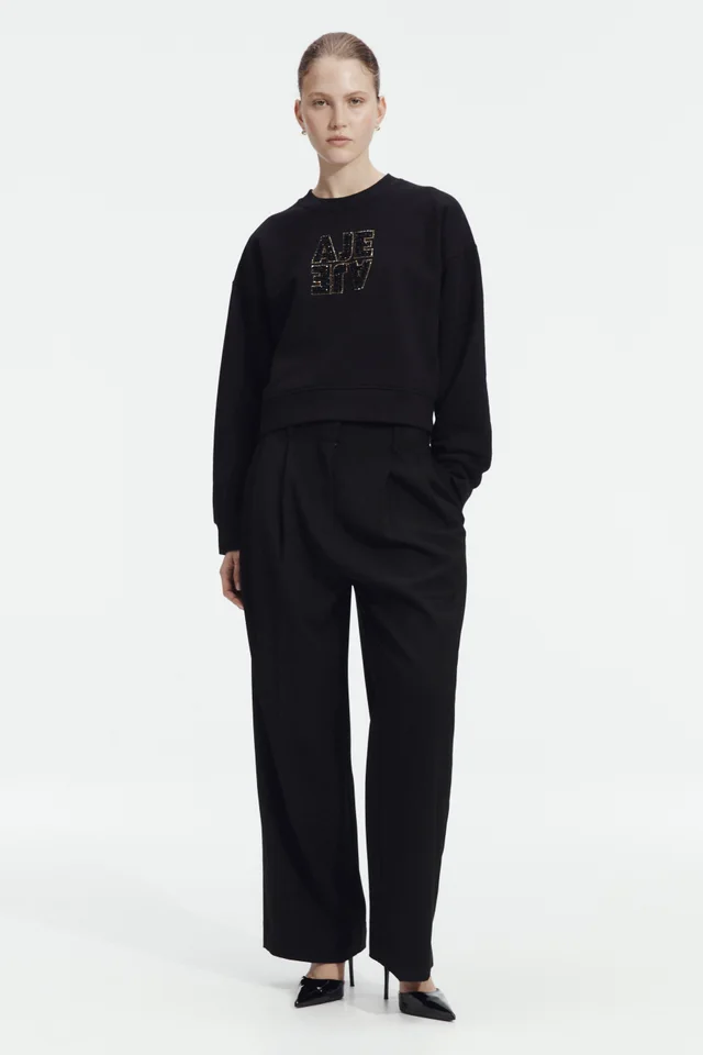 AJE Amina Logo Sweater in Black from Aje, photo 1 of 1