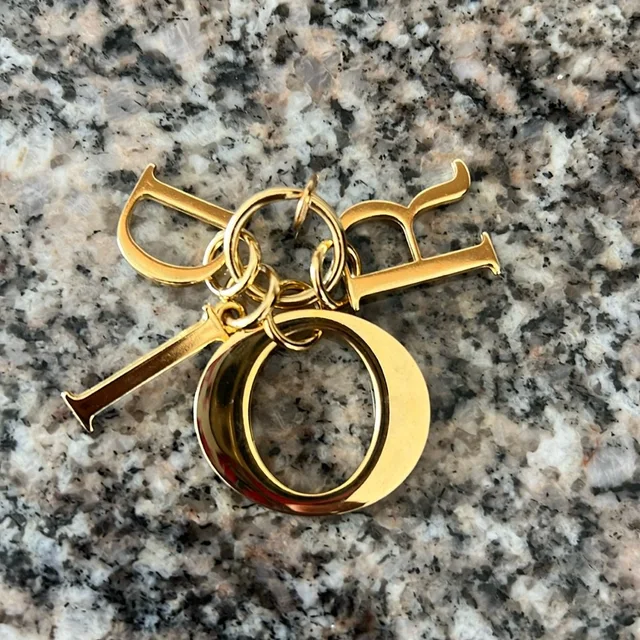 Dior Gold Charm in gold from Poshmark