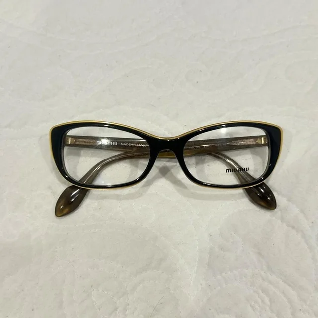 Miu Miu Women's Sunglasses - Brown/Black in red|brown|black from Depop, photo 1 of 1