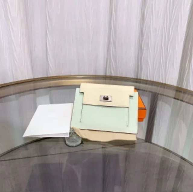 Hermès color-blocked Kelly Pocket coin purse, engraved with charm. from Luxury Promise