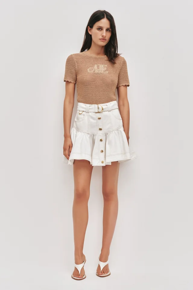 AJE Elena Belted Denim Mini Skirt in White from Aje, photo 1 of 1