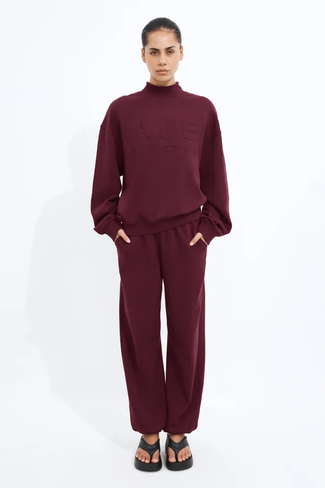 Athletica Cuffed Hem Logo Track Pants in Red from Aje, photo 1 of 1