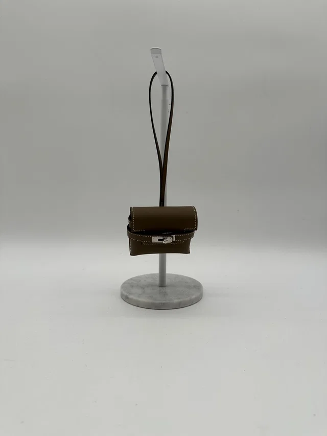 Hermès Kellyfestival charm étoupe Swift in Taupe Swift leather from Luxury Promise