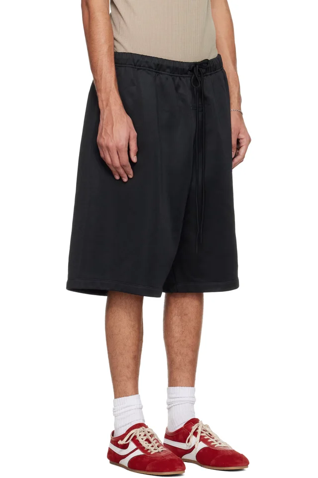 Fear of God ESSENTIALS Black Holiday Satin Fleece Relaxed Shorts, photo 2 of 4 from SSENSE
