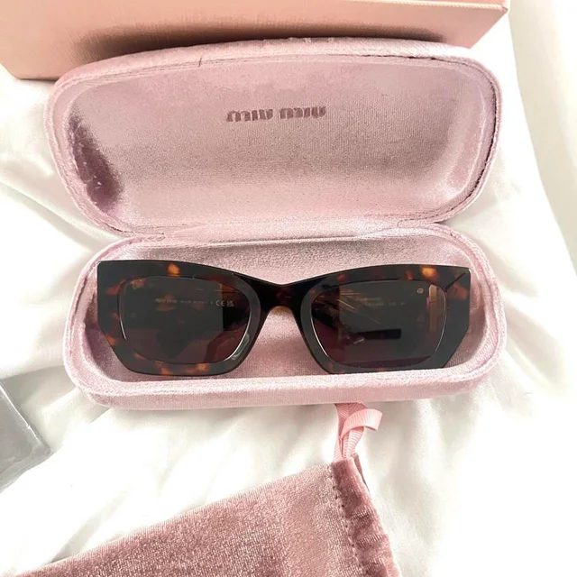 Miu Miu Women's Cat eye Sunglasses - Brown/Black in red|black|brown from Depop, photo 4 of 6