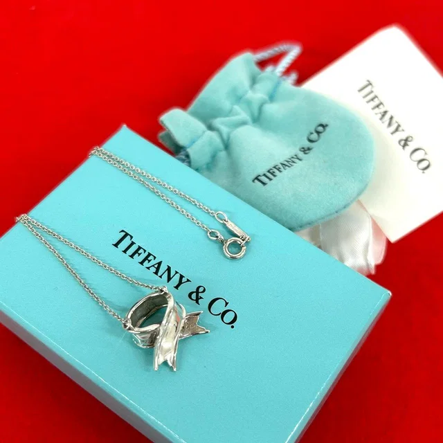 Tiffany & Co. Box Vintage Cross Ribbon Necklace 925 Sterling Silver Pendant in Silver from The Reluxe