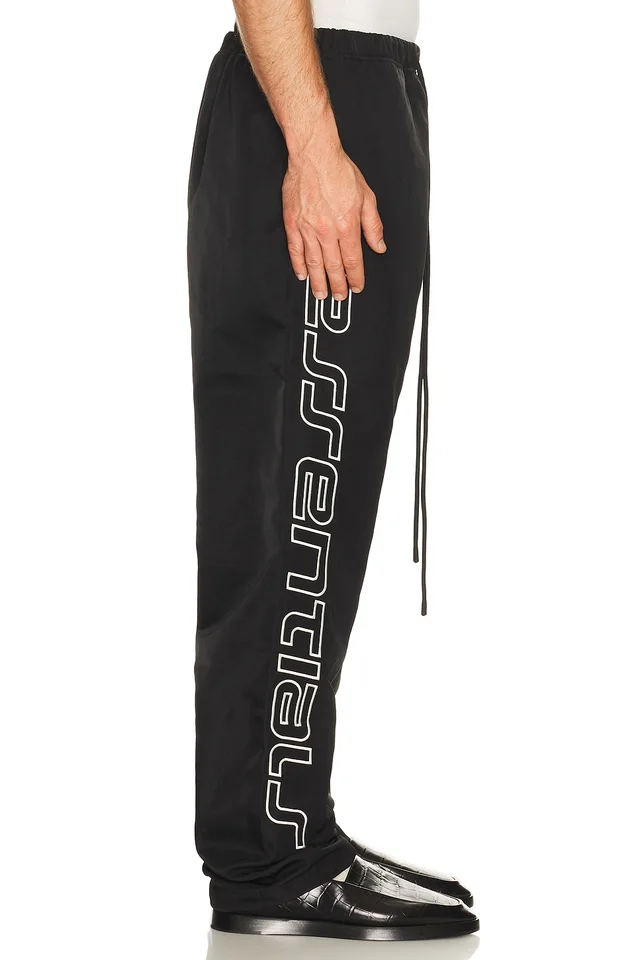 Fear of God ESSENTIALS Active Trace Relaxed Drawstring Pant in Vintage Black, photo 2 of 7 from REVOLVE (Canada)