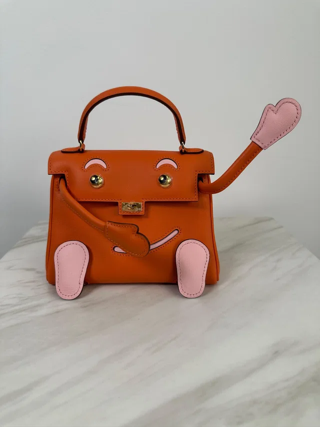 Hermès Kelly Doll Orange & Rose Sakura Swift Palladium Hardware in Pink Swift leather from Luxury Promise