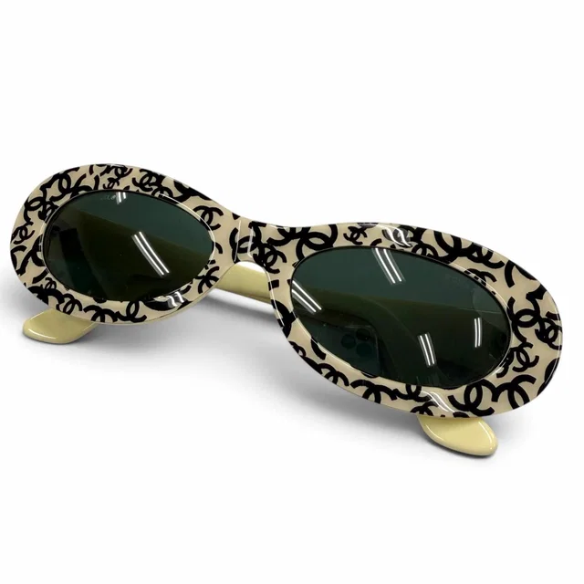 Chanel Vintage CC Logo All Over Print Oval Eyewear Sunglasses Ivory Black Demo in Black from The Reluxe
